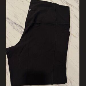 Athleta Black Salutation Stash Tight with pockets